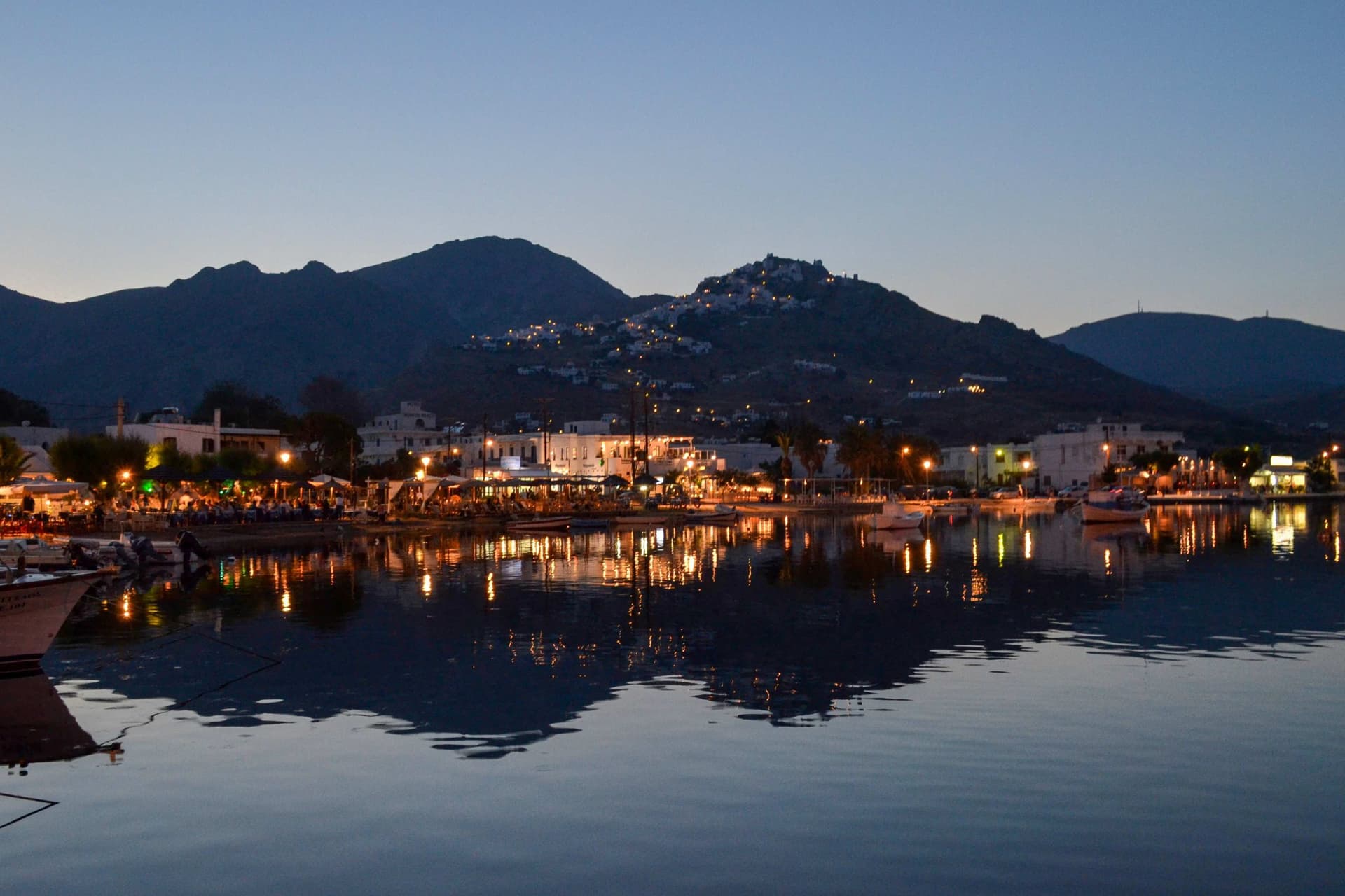 Evening lights twinkle across the shore of S