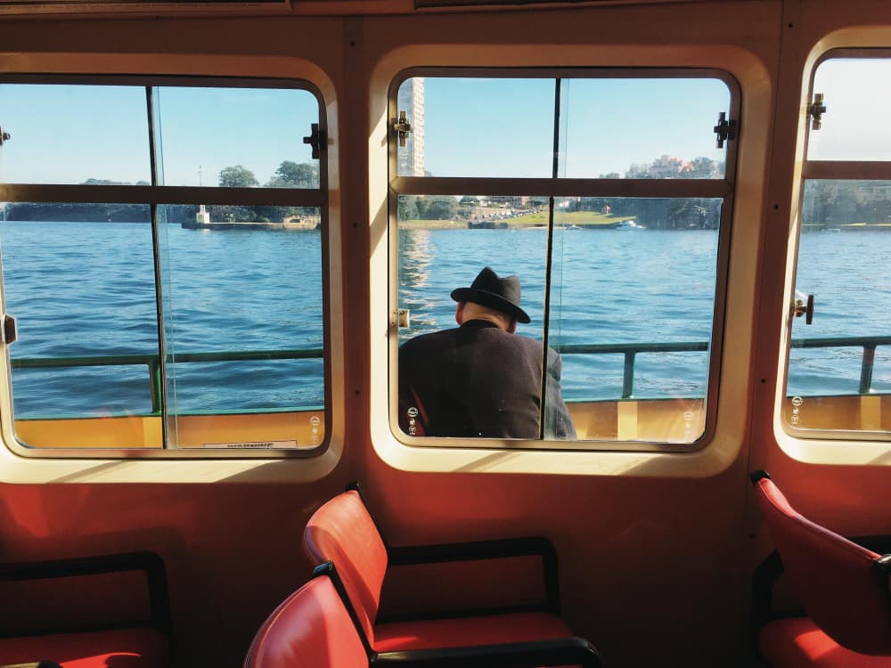A serene moment aboard a ferry, as seen from the interior through large windows