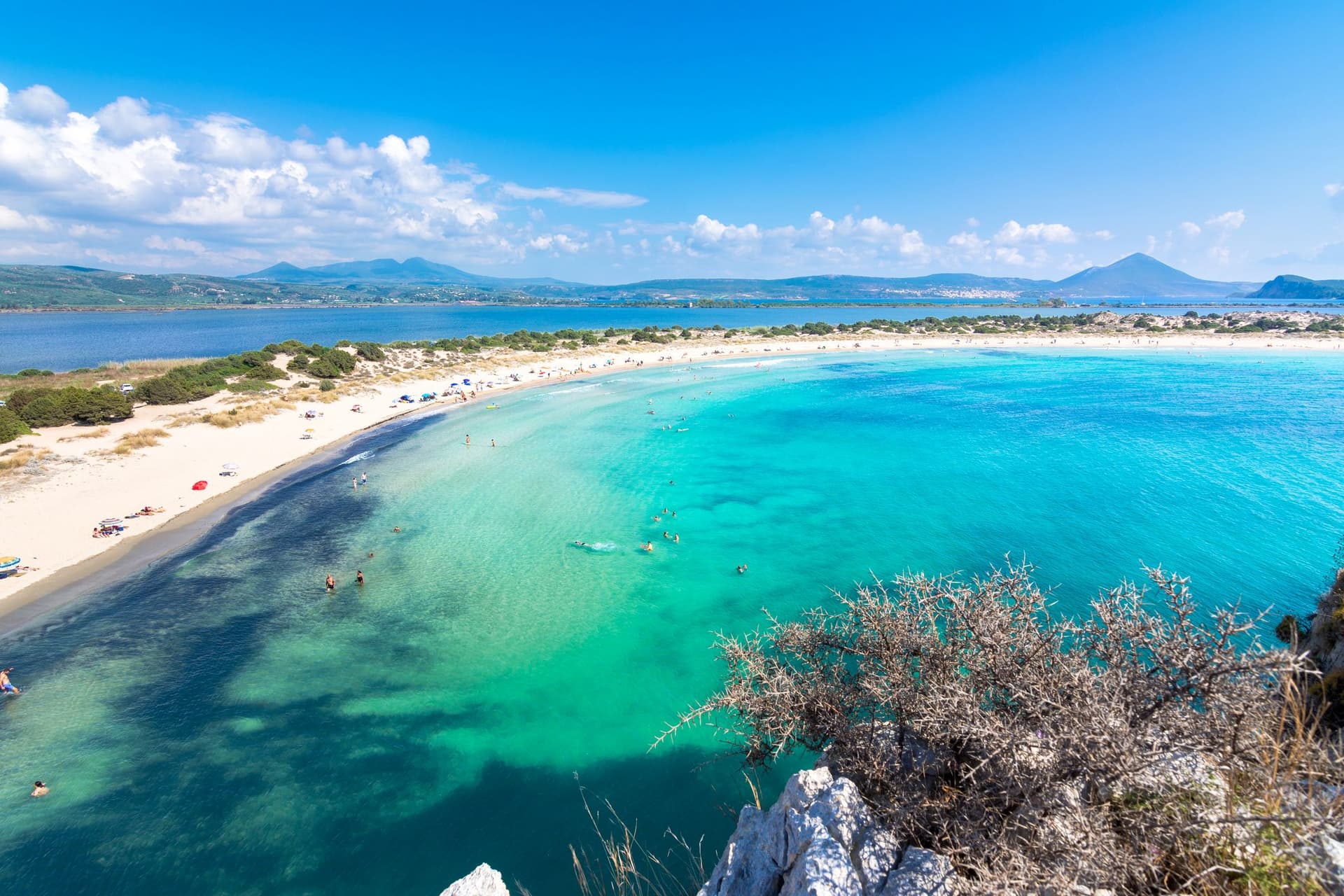 Aerial shot of Voidokilia Beach's turquoise waters.